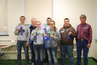 Members of the Mountrail County team of (from left) Myles Odermann, Jonathan Rosencrans, Haley Goodall, Dylan Enger, Michelle Risan and Daniel Bolen, accompanied by their coach, Gary Martens, show off the ribbons they received in the senior division of the state 4-H meat judging contest at NDSU.