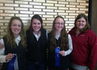 Members of the Ward County 4-H hippology team display the ribbons they received for taking first place in the senior division of the hippology contest at the North Dakota Winter Show. Pictured  (from left) are team members Shaylee Miller, Parker Bush and Kara Scheresky, and coach Paige Brummund. (Not pictured is team member Lindsey Sys.)