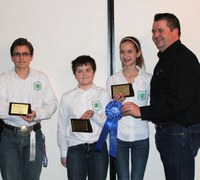 The combined LaMoure/Grand Forks County team took first place in the junior division of the crop judging contest at the North Dakota Winter Show. Team members are (from left) Thomas Granger of Grand Forks County, and Zach Lahlum and Eva Lahlum of LaMoure County. They are accompanied by their coach, Eric Lahlum (far right).