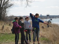 Alicia Biewer of Richland County takes aim at a 3-D alligator target in the 4-H Spring Shooting Sports State Match held at the North Dakota 4-H Camp near Washburn while her team's coach, Jodi Sander (far left) and Katelyn Loewen and Jaidyn Sander of Richland County watch.