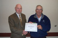 Ken Grafton, vice president for Agricultural Affairs, director of the North Dakota Agricultural Experiment Station and dean of the College of Agriculture, Food Systems, and Natural Resources (left), presents the award to Jerald Bergman.