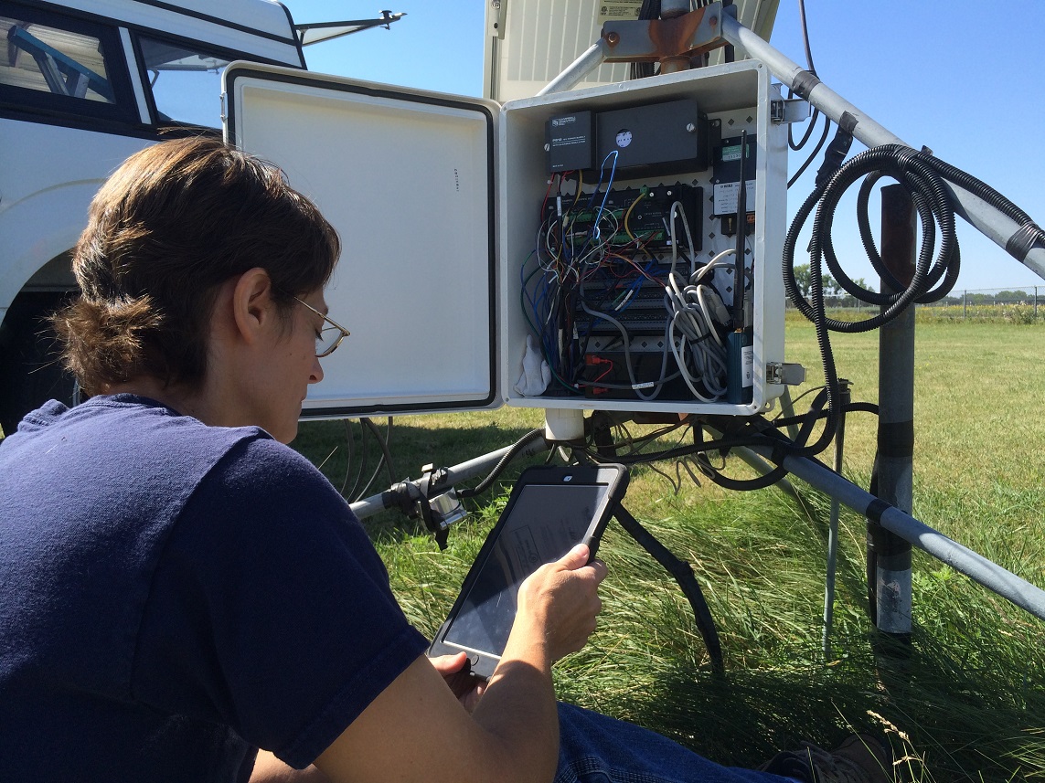 Barb Mullins, NDAWN data acquisition manager, doing maintenance on