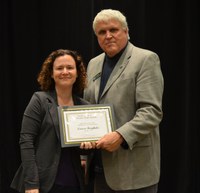 David Buchanan, associate dean for academic programs in the College of Agriculture, Food Systems, and Natural Resources, presents the Earl and Dorothy Foster Excellence in Teaching Award to Teresa Bergholz, assistant professor, Department of Veterinary and Microbiological Sciences. (NDSU photo)