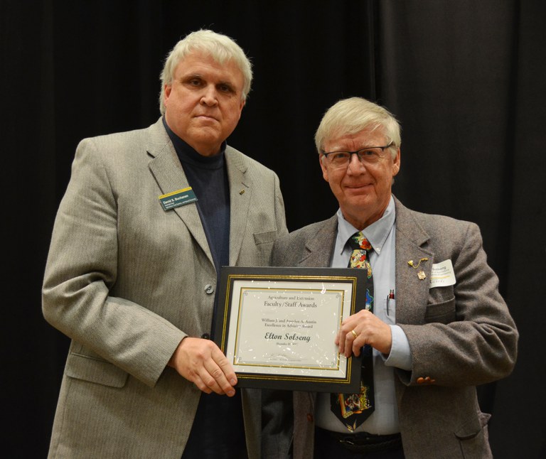 David Buchanan, associate dean for academic programs in the College of Agriculture, Food Systems, and Natural Resources (left), presents the William J. and Angelyn A. Austin Excellence in Advising Award to Elton Solseng, instructor, Department of Agricultural and Biosystems Engineering. (NDSU photo)