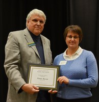 David Buchanan, associate dean for academic programs in the College of Agriculture, Food Systems, and Natural Resources, presents the Donald and Jo Anderson Staff Award to Kamie Beeson, information systems management and secretarial support services, Department of Plant Sciences. (NDSU photo)