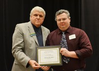 David Buchanan, associate dean for academic programs in the College of Agriculture, Food Systems, and Natural Resources (left), presents the Larson/Yaggie Excellence in Research Award to Jason Harmon, assistant professor, School of Natural Resource Sciences (Entomology). (NDSU photo)