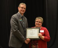 NDSU Extension Director Chris Boerboom presents the AGSCO Excellence in Extension Award to Rita Ussatis, Extension agent, Cass County. (NDSU photo)