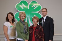 The Grinde-Bergstrom family was named a North Dakota 4-H century family. Pictured are, from left, Leann Schafer, chairwoman of the North Dakota 4-H Foundation board; Denise Bergstrom; Elenore Grinde; and Chris Boerboom, NDSU Extension Service director. (NDSU photo)