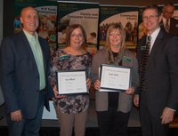 Patrick Sitter (far left), general manager, Farm and Ranch Guide, and Chris Boerboom, NDSU Extension Service director, present a Program Excellence Award to Jean Noland (second from left), Extension agent, Expanded Food and Nutrition Education Program, Grand Forks County; and Linda Kuster, nutrition education assistant, Family Nutrition Program, Grand Forks County, for the Savvy Shopping program. (NDSU photo)