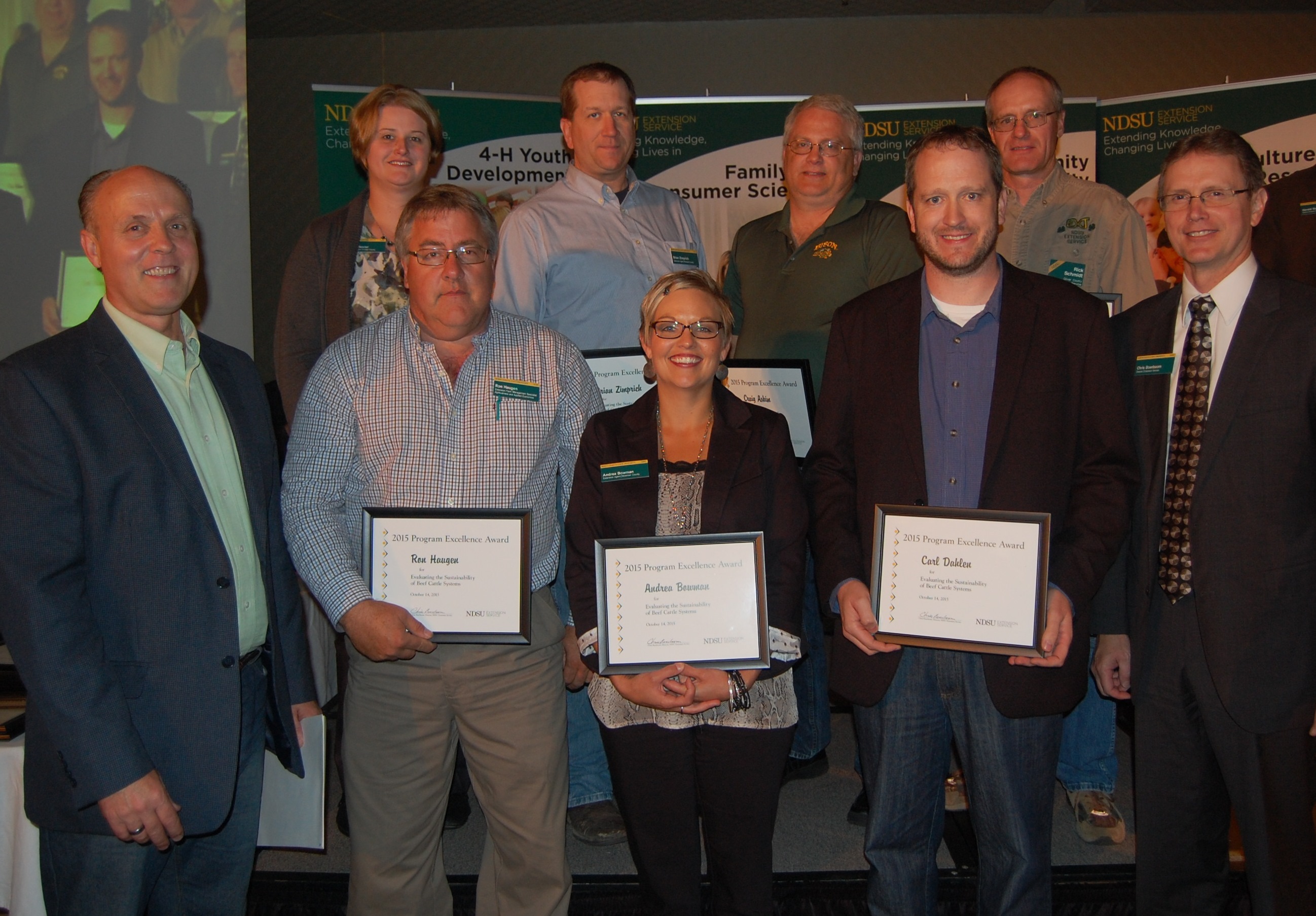 Patrick Sitter, general manager of Farm and Ranch Guide, and Chris Boerboom, NDSU Extension director, present a Program Excellence Award to this team for developing a program to evaluate the sustainability of beef cattle breeding systems. Pictured are (front row, left to right) Sitter; Ron Haugen, Extension farm management specialist; Andrea Bowman, Extension agent, agriculture and natural resources, Bowman County; Carl Dahlen, Extension beef cattle specialist; Boerboom; (back row, left to right) Penny Nester, Extension agent, agriculture and natural resources, Kidder County; Brian Zimprich, Extension agent, agriculture and natural resources, Ransom County; Craig Askim, Extension agent, agriculture and natural resources, Mercer County; Rick Schmidt, Extension agent, agriculture and natural resources, Oliver County (NDSU photo)