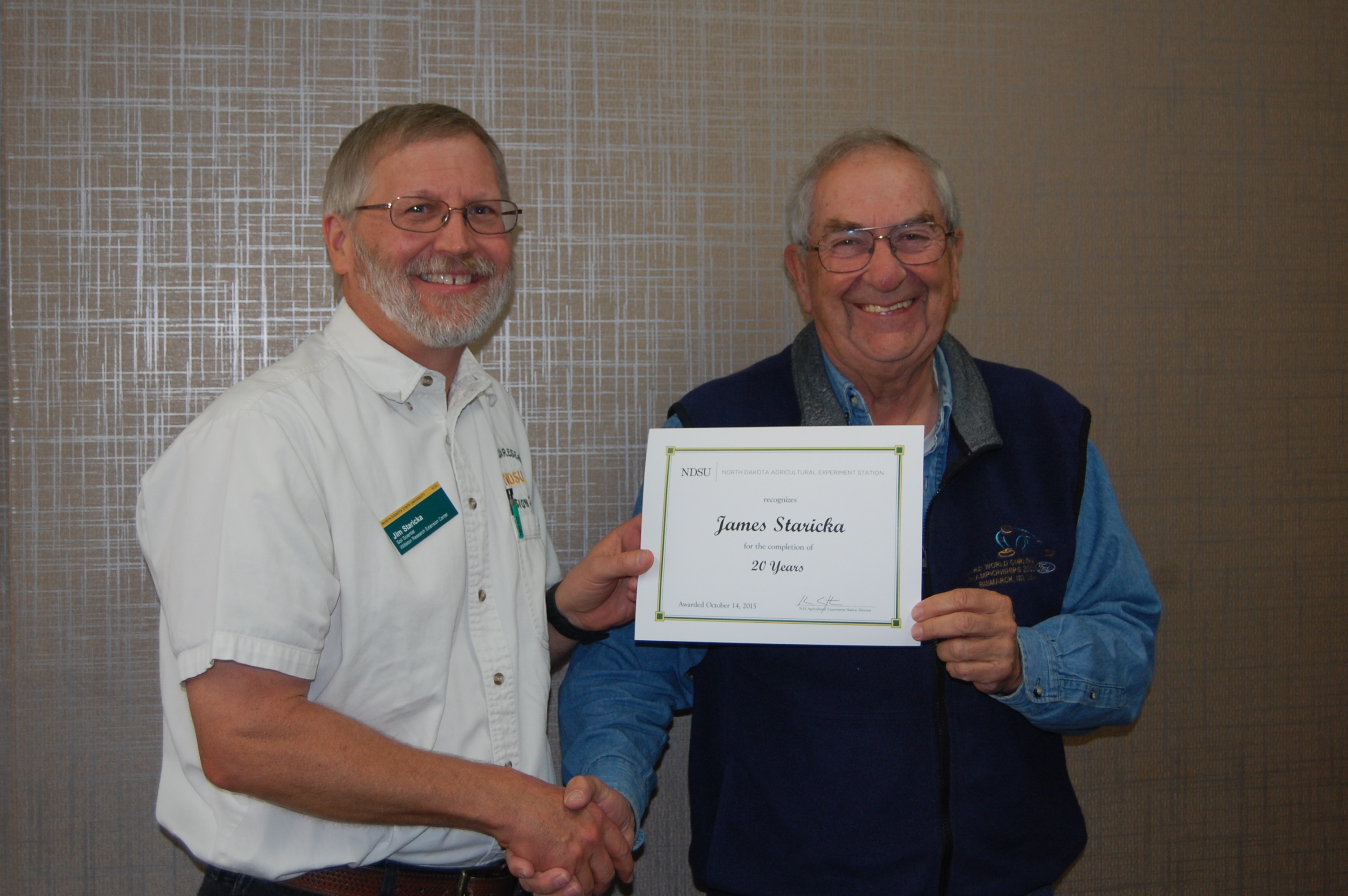 Jim Staricka (left; award presented by Jerry Bergman, WREC director, right)