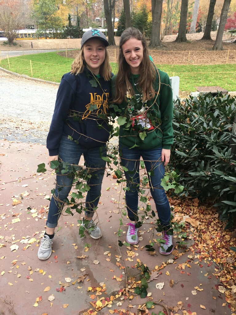 North Dakota 4-H'ers Marit Wang, left, and Avery Breiland remove an invasive species of ivy at the Atlanta History Museum as a community service project that was part of the National 4-H Congress activities. (NDSU photo)