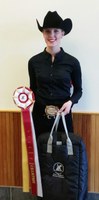Courtney Bolstad shows off her ribbon after being named reserve champion in intermediate horsemanship in regional competition. (NDSU photo)