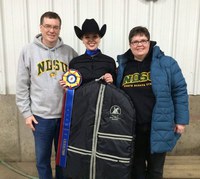 Sarah Garrison celebrates with her parents, John and Carole Garrison, after she is named champion in novice horsemanship in regional competition. (NDSU photo)
