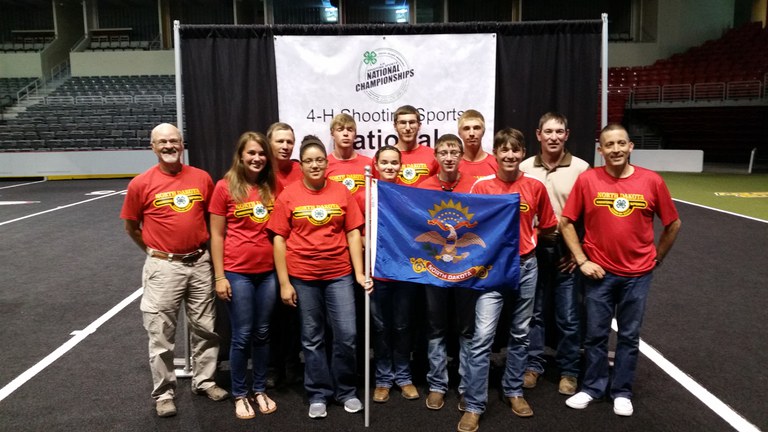 Eight youth represent North Dakota in the 4-H Shooting Sports National Championships in Grand Island, Neb. Pictured are: (front row, from left): coach Rick Jorgenson, Erin Morstad, Maria Rosa-Nieves, Shaelynn Tofte, Brandon Alexander, Kail Larson and coach Jose Figuero-Diaz; (back row) coach Dave Morstad, Mason Hanson, Max Shuh, Christopher Morstad and coach Eudell Larson. (NDSU photo)