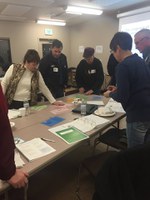 Design Your Succession Plan program participants in Beulah are looking at workshop materials. (NDSU photo)