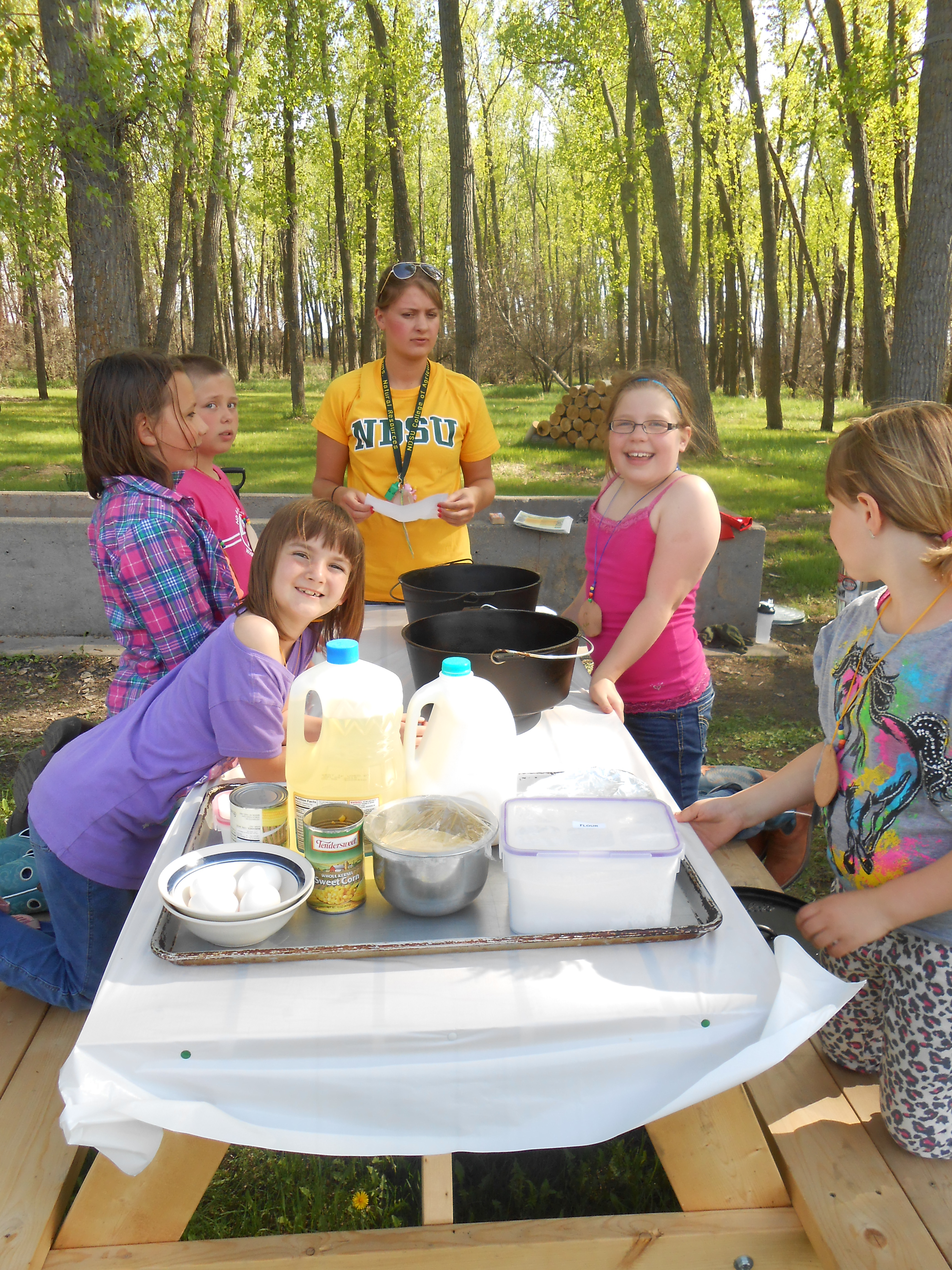 Youth receive a lesson in outdoor cooking at the North Dakota 4-H Camp near Washburn. (NDSU photo)