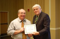 Frank Manthey, left, receives the Eugene R. Dahl Excellence in Research Award from David Buchanan, associate dean for academic programs. (NDSU photo)