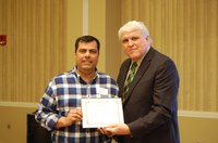 Juan Osorno, left, receives the Larson/Yaggie Excellence in Research Award from David Buchanan, associate dean for academic programs. (NDSU photo)