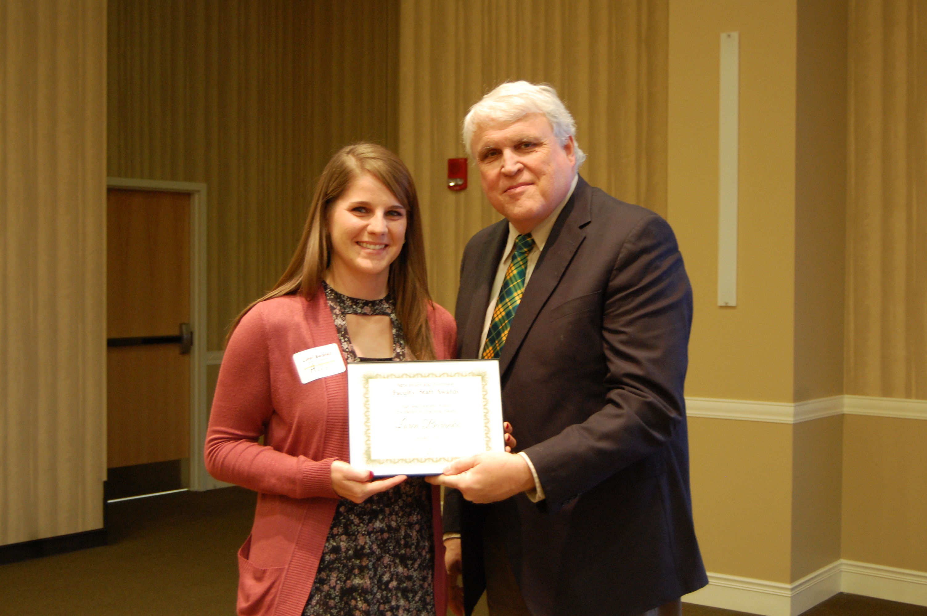 Loren Baranko receives the Earl and Dorothy Foster Excellence in Teaching Award from David Buchanan, associate dean for academic programs. (NDSU photo)