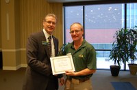 Rick Schmidt. right, receives the AGSCO Excellence in Extension Award from NDSU Extension Director Chris Boerboom. (NDSU photo)