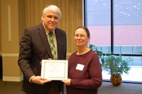 Shelley Horne receives the Charles and Linda Moses Staff Award from David Buchanan, associate dean for academic programs, (NDSU photo)