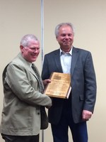 Myron Blumhagen (left), a producer from Drake, receives the Distinguished Service Award from Del Gates, president of the North Dakota Crop Improvement and Seed Association. (NDSU photo)