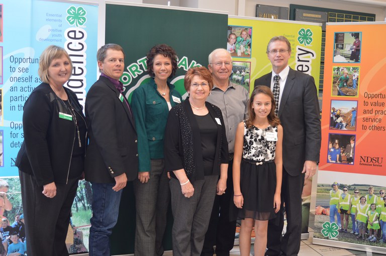 The Ellingson/Schaff family of Morton County is named a 4-H century family. Pictured are, from left: Tammy Meyer, chair of the North Dakota 4-H Foundation board; Chad Ellingson; Julie Ellingson; Angie Schaff; Martin Schaff; Medora Ellingson; and Chris Boerboom, NDSU Extension Service director. (NDSU photo)