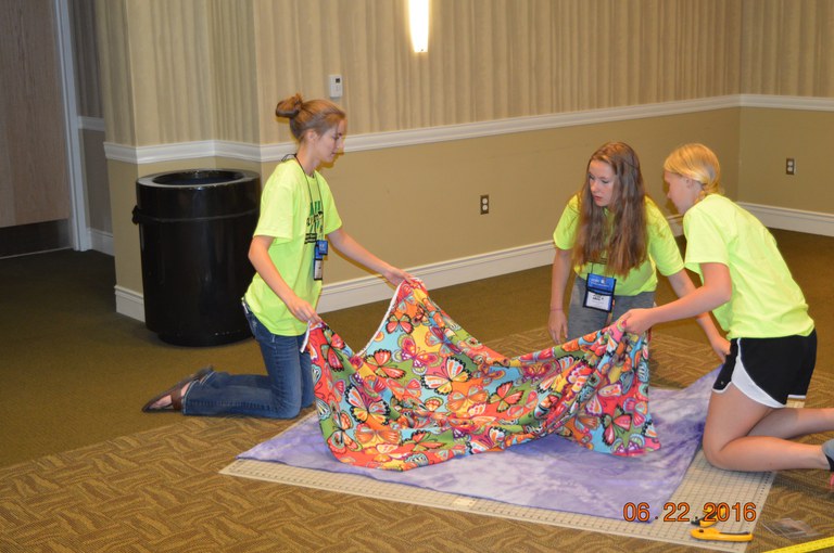 Youth make blankets as a community service project during the Extension Youth Conference in Fargo. (NDSU photo)