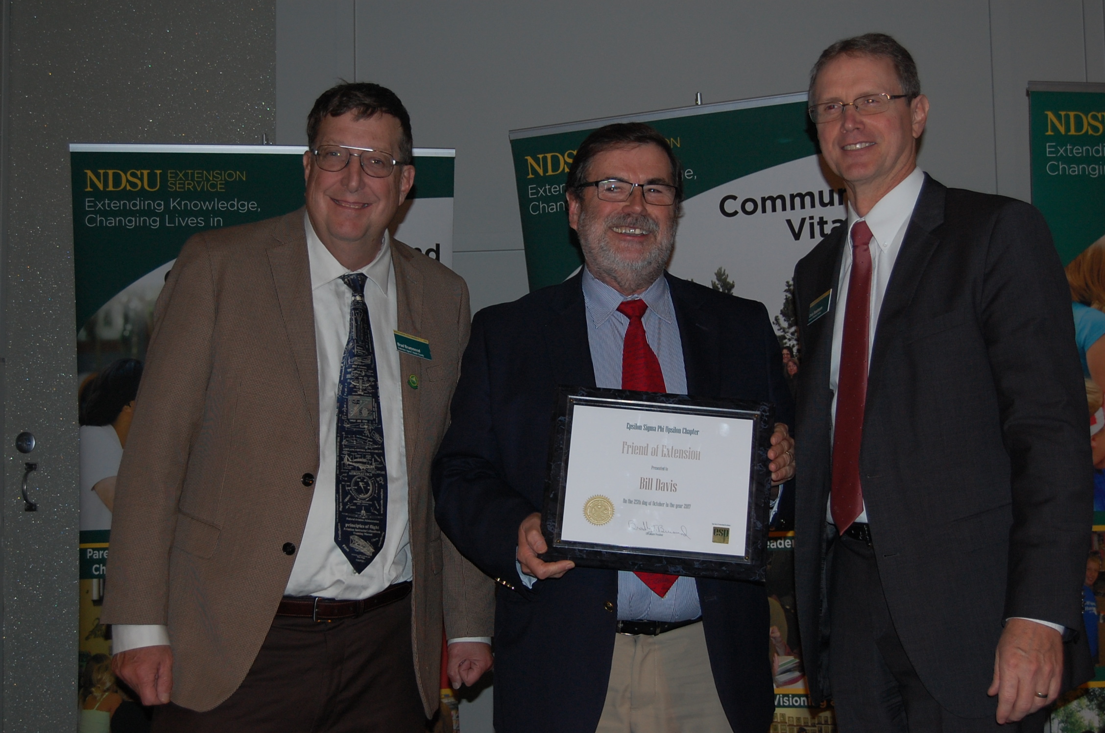 Bill Davis (center), receives the Friend of Extension Award from Brad Brummond, an agent in NDSU Extension's Walsh County office and president of the Upsilon Chapter of Epsilon Sigma Phi  (left), and NDSU Extension Director Chris Boerboom. (NDSU photo)