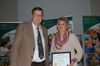 Dawn Alderin receives the Meritorious Support Service Award from Brad Brummond, an agent in NDSU Extension's Walsh County office and president of the Upsilon Chapter of Epsilon Sigma Phi. (NDSU photo)