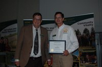 Greg Endres (right) receives the Visionary Leadership Award from Brad Brummond, an agent in NDSU Extension's Walsh County office and president of the Upsilon Chapter of Epsilon Sigma Phi. (NDSU photo)