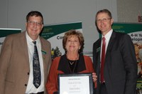 Renae Korslien receives a Friend of Extension Award from Brad Brummond, an agent in NDSU Extension's Walsh County office and president of the Upsilon Chapter of Epsilon Sigma Phi  (left), and NDSU Extension Director Chris Boerboom. (NDSU photo)