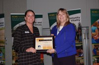 Mary Mertens, North Dakota Farmers Union member relations specialist (left), receives the 2017 Friend of the North Dakota Extension Association of Family and Consumer Sciences from Julie Garden-Robinson, NDSU Extension food and nutrition specialist and president of the association. (NDSU photo)