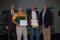 Extension agents Craig Askim, Mercer County (second from left), and Duaine Marxen, Hettinger County, receive a Program Excellence Award for Farm Saftey Day from NDSU Extension Director Chris Boerboom, left, and Jim Murphy, Farm and Ranch Guide (far right). (NDSU photo)
