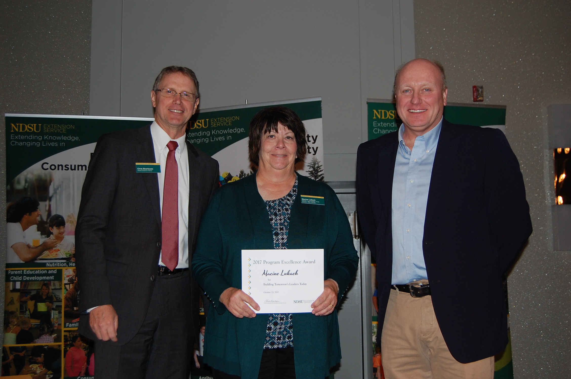 Macine Lukach, an agent from NDSU Extension's Cavalier County, receives a Program Excellence Award for the Building Tomorrow's Leaders Today program from NDSU Extension Director Chris Boerboom (left) and Jim Murphy, Farm and Ranch Guide. (NDSU photo)