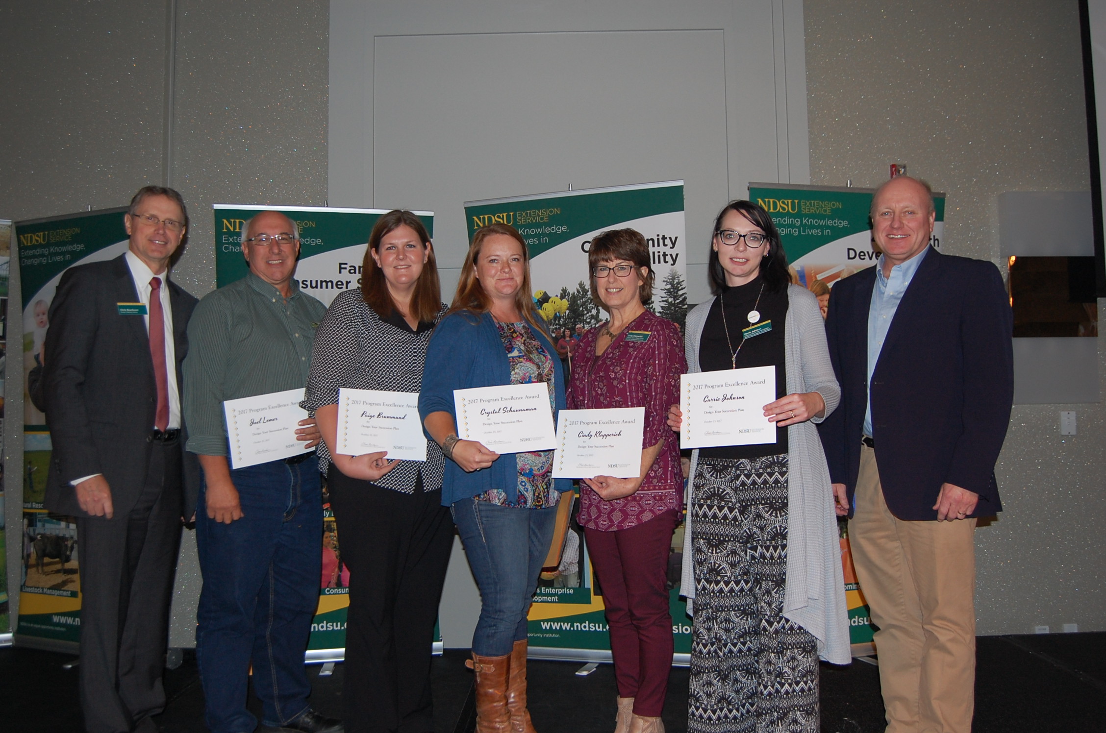 The Design Your Succession Plan team receives its Program Excellence Award. Pictured are (from left): NDSU Extension Director Chris Boerboom; agent Joel Lemer, Foster County; agent Paige Brummund, Ward County; agent Crystal Schaunaman, McIntosh County; agent Cindy Klapperich, Saregent County; Carrie Johnson, Extension family finance specialist; and Jim Murphy, Farm and Ranch Guide. (NDSU photo)