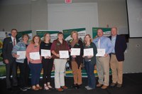 The Sheep to Sweater (and More) team receives a Program Excellence Award. Pictured are (from left): NDSU Extension Director Chris Boerboom; agent Leigh Gunkel, Griggs County; agent Megan Vig, Griggs County; agent Katelyn  Hain, Nelson County; agent Angie Johnson, Steele County; agent Kristi Berdal, Nelson County; Stacy Wang, Extension associate; Travis Hoffman, Extension sheep specialist; and Jim Murphy, Farm and Ranch Guide. (NDSU photo)