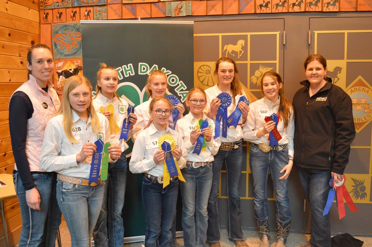 A Ward County team took first place in junior division horse judging and intermediate division hippology. Pictured are, from left (front row): coach Emily Goff and team members Mackenzie Wipf, Haley Buck and Sadie Lemer; (back row); team members Macey Moore, Hailey Schauer, Anne Schauer and Emily Fannik, and coach Paige Brummund. (NDSU photo)