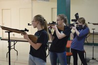 Cass County air rifle team members (from left) Rebecca Van Vleet, Mercedes Francis and Lillian Roth take aim at the 4-H State Air Rifle Match in Devils Lake. (NDSU photo)