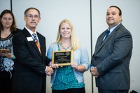 Alicia Harstad, NDSU Extension agriculture and natural resources agent in Stutsman County, receives the Achievement Award from Alan Galloway, president of the National Association of County Agricultural Agents (left) and Bill Viar from the American Income Life Insurance Co., which sponsored the award. (Photo courtesy of NACAA)