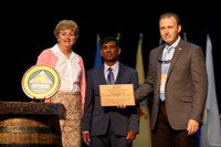 Mohamed Khan, NDSU Extension sugar beet specialist (center) receives the National Creative Excellence Award from Elizabeth Claypoole, president of Epsilon Sigma Phi, and James Henderson, president of the Association of Natural Resource Extension Professionals. (Photo courtesy of NACAA)