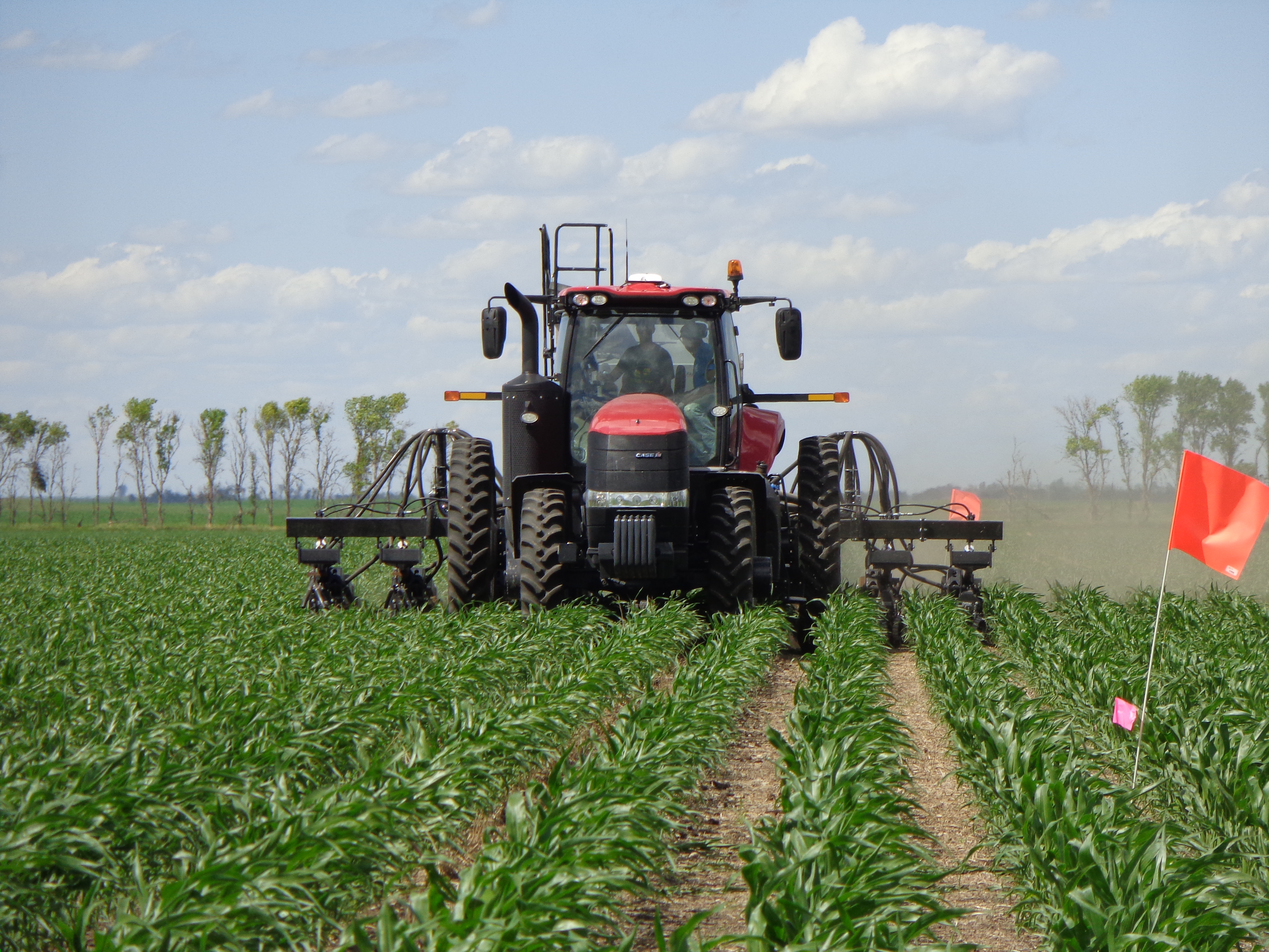 NDSU reseachers interseed cover crops in a field plot near Rutland. (NDSU Photo)