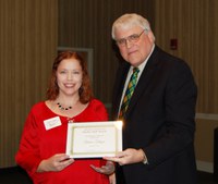 Aimee Thapa, left, receives the Donald and Jo Anderson Staff Award from David Buchanan, associate dean for academic programs. (NDSU photo)