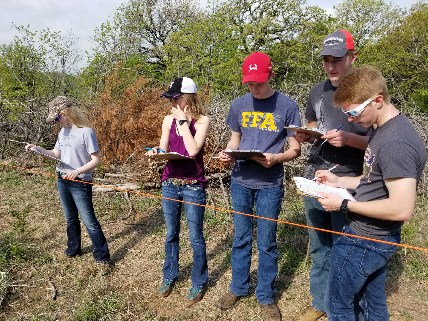 Foster County's 4-H range management team evaluates a range site. Pictured are (from left): Beth Lee, Chayla Kuss, Tyler Lee, Mathias Kubal and Adam Gorseth. (NDSU photo)