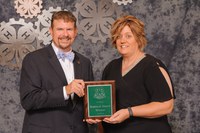 Karla Meikle receives the Distinguished Service Award from Jim Thompson, NAE4-HA executive director. (Photo courtesy of NAE4-HA)
