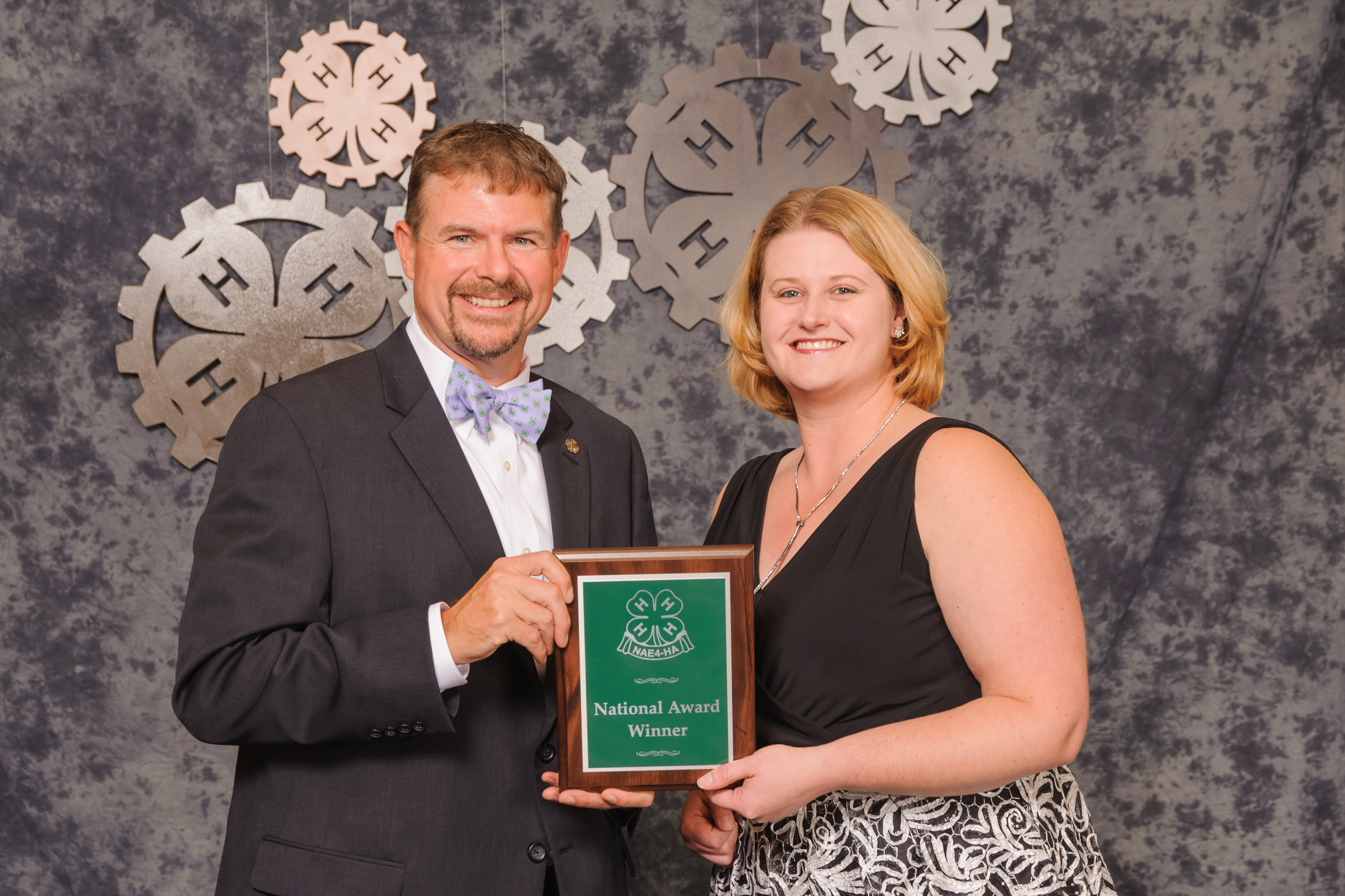 Penny Nester receives the Distinguished Service Award from Jim Thompson, NAE4-HA executive director. (Photo courtesy of NAE4-HA)