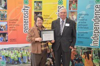 Myrene and Andrew Peterson receive the North Dakota 4-H Century Family recognition on behalf of their family. (NDSU photo)