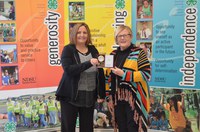 Barb DeTienne, right, receives North Dakota's Outstanding Lifetime 4-H Volunteer Award from Lynnette Vachal, NDSU Extension 4-H youth development agent in Mountrail County. (NDSU photo)