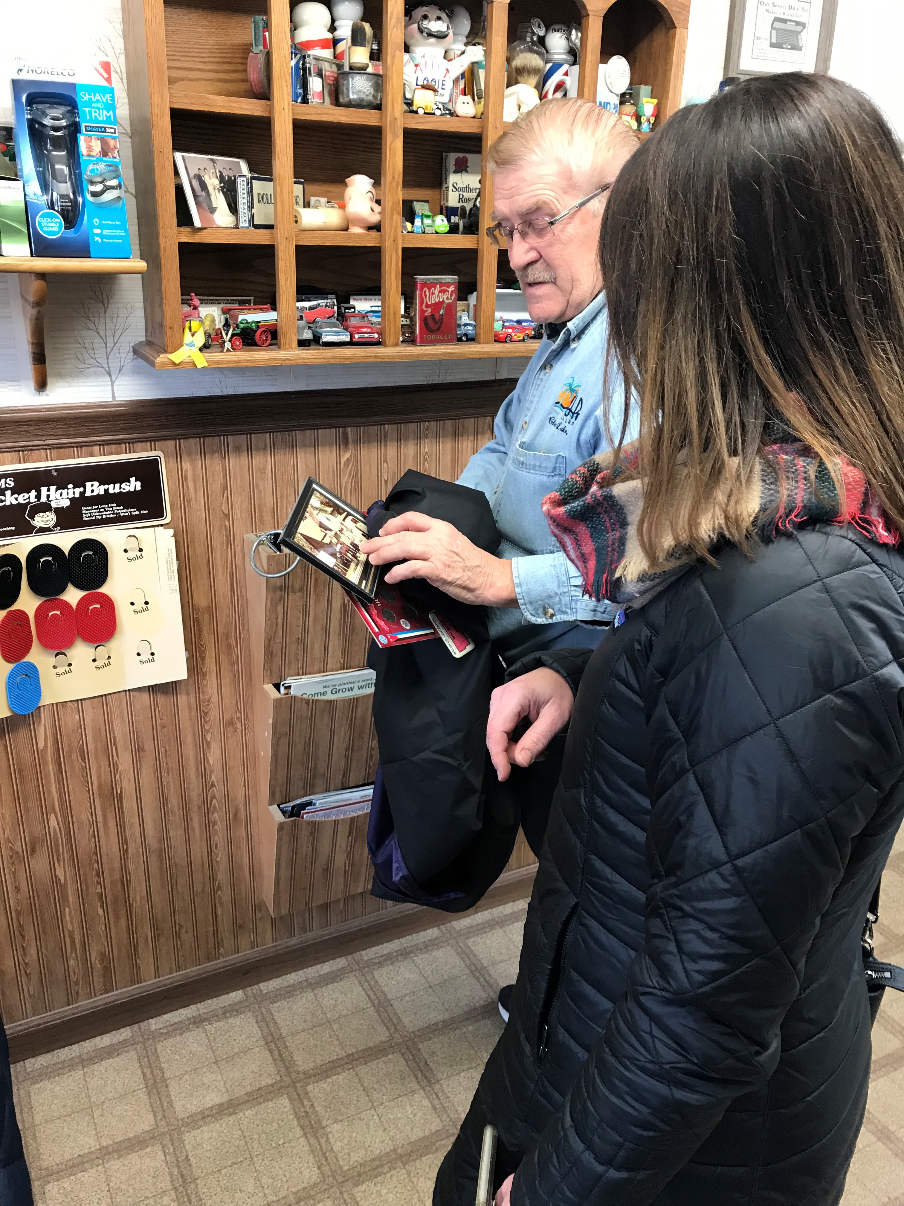 Julie Falk of Hankinson chats with Park River barber George Moen when a group of Hankinson residents makes an unannounced visit to Park River as part of NDSU Extension’s Community Impressions program. (NDSU photo)